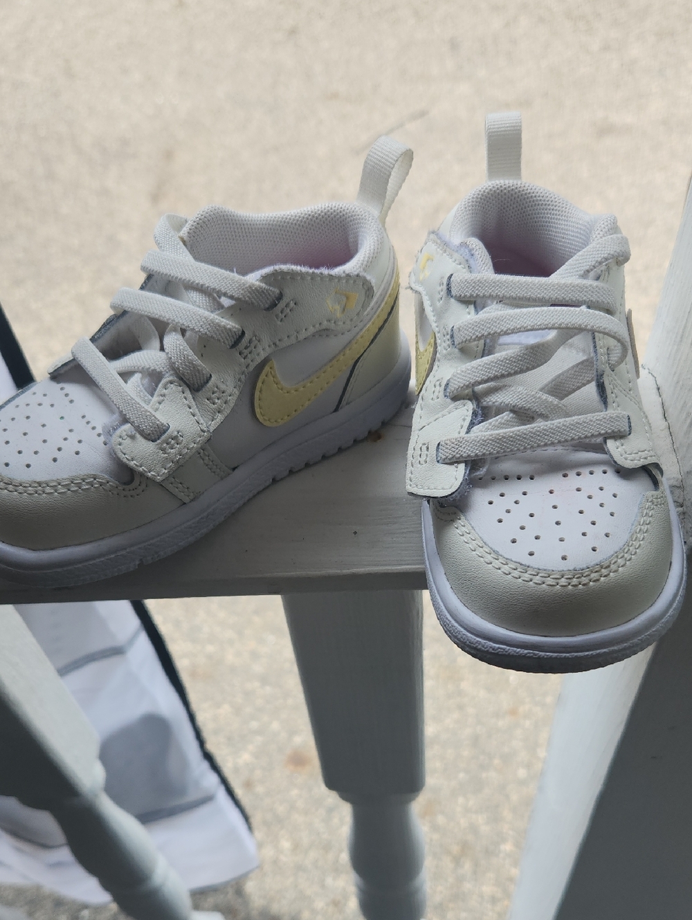 Nike Kids White Sneakers with Pale Yellow Swoosh